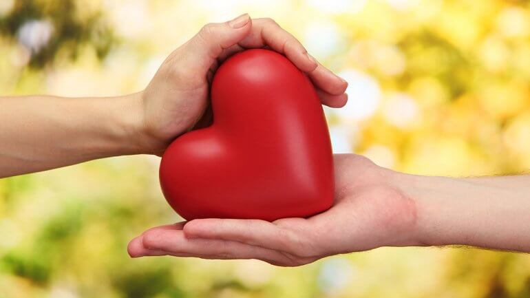 two hands holding small heart