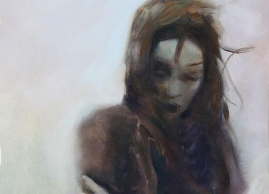 woman with arms crossed and hair in the air