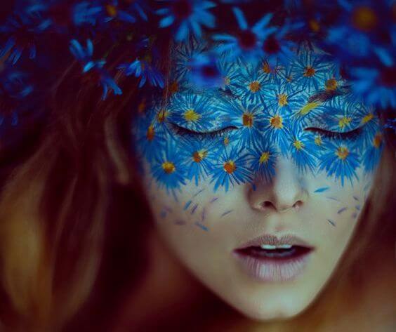 woman with mask of blue flowers