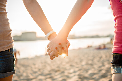 female couple holding hands