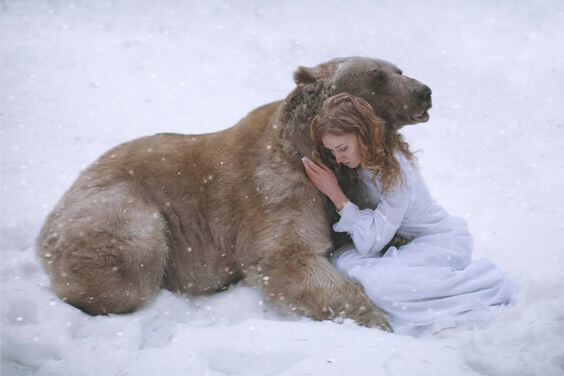 girl hugging a bear