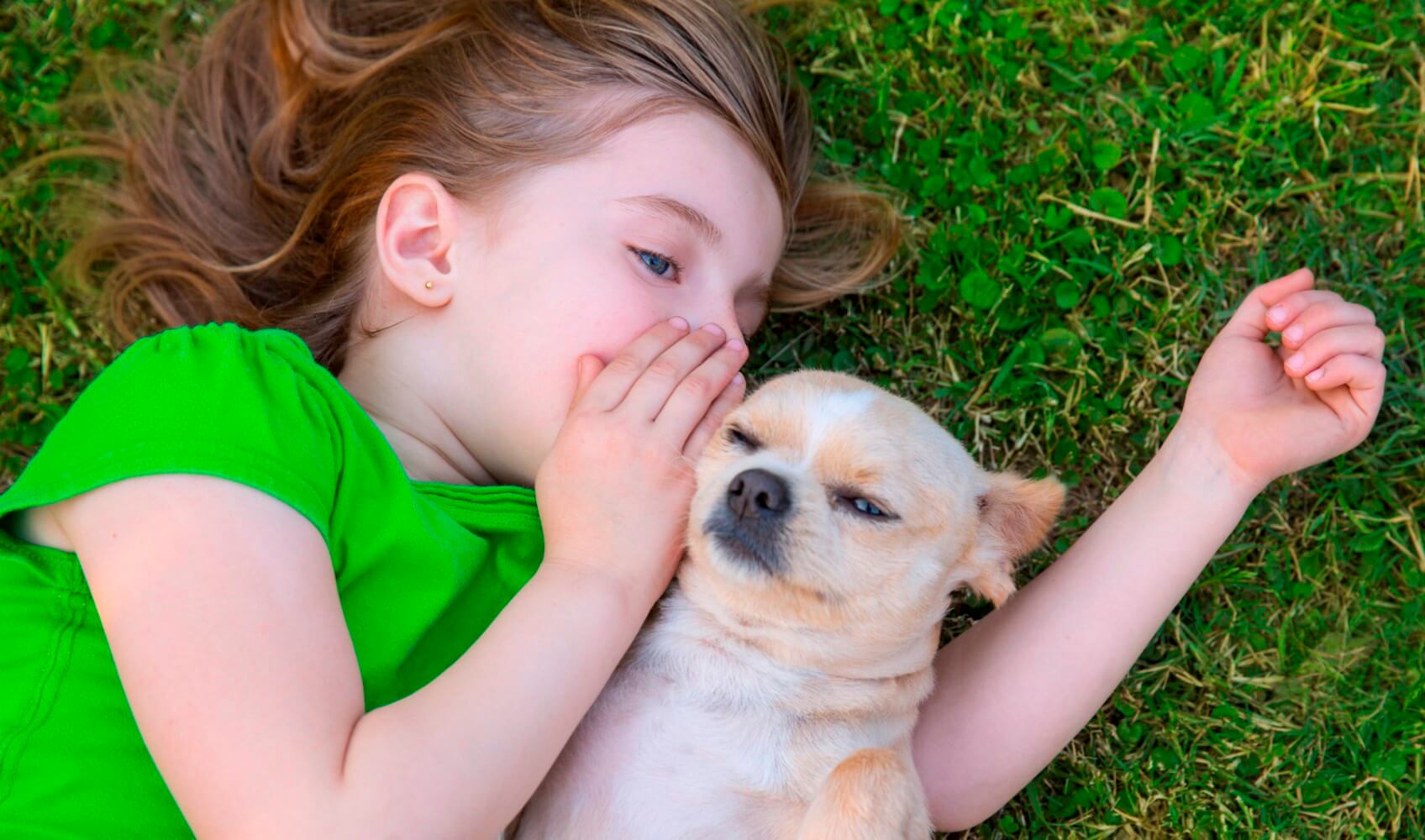girl whispering in dogs ear