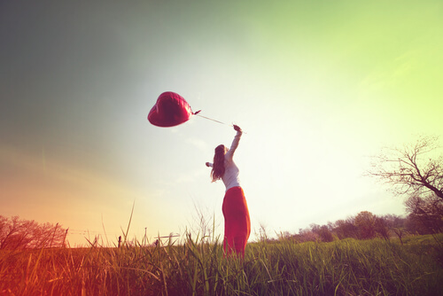 girl with balloon in field