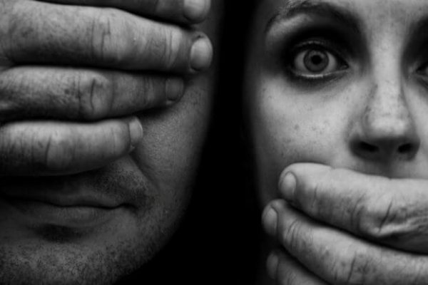 man silencing woman
