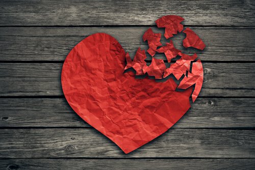 paper heart torn on wood