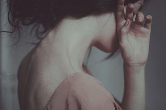 woman covering her face