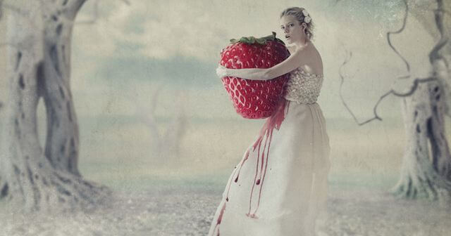woman hugging giant strawberry