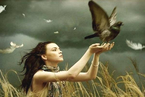 woman letting bird free