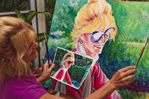 woman painting a happy painting