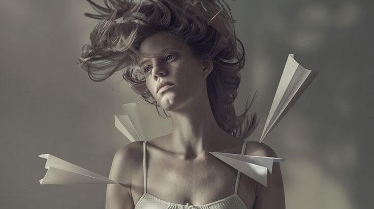 woman with paper planes on her body