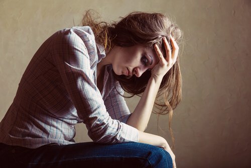Stressed Woman With Head in Hands