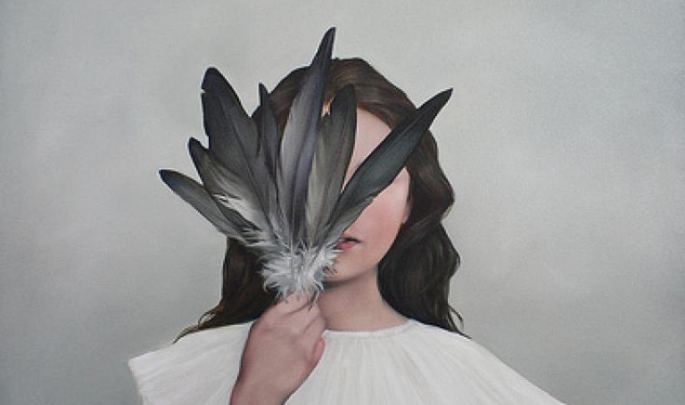 Woman Covering Face with Feathers