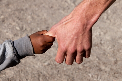 child holding man's hand