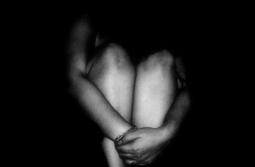 Depressed Person in Ball in Shadows