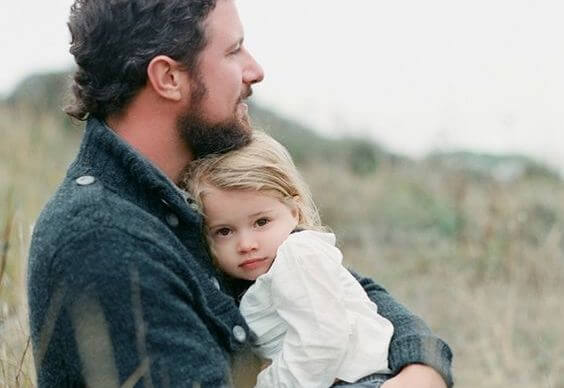 father hugging his daughter