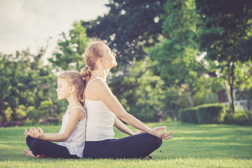 mother and daughter meditating