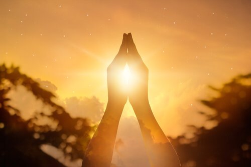 sun peaking through hands