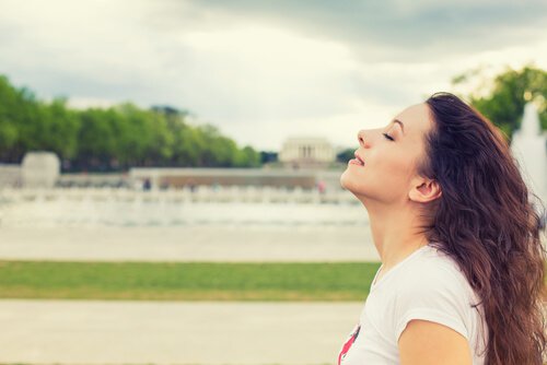 woman eyes closed enjoying breeze