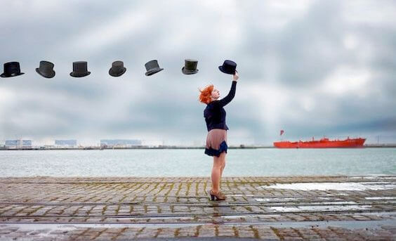 woman holding a hat