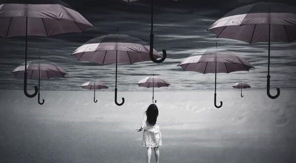 woman reaching for umbrellas in the sky