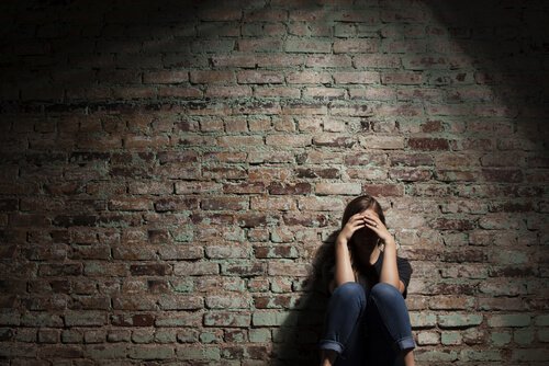 Sad Woman Against Brick Wall