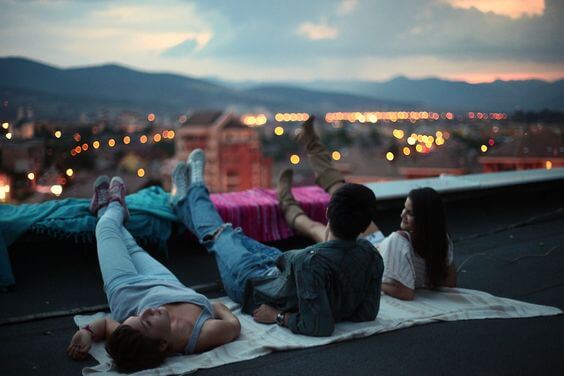 Some friends on a roof at night.