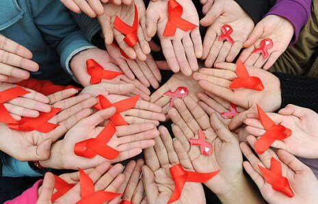each hand holding red ribbon