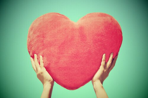 holding up big fuzzy heart