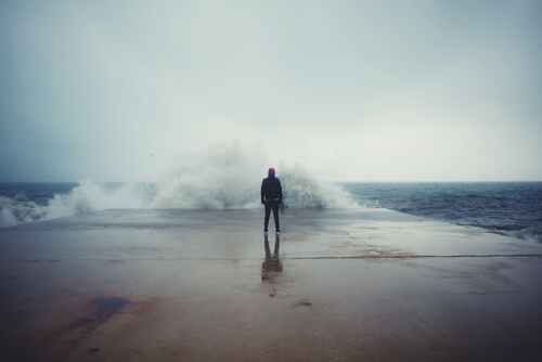 man in front of a wave