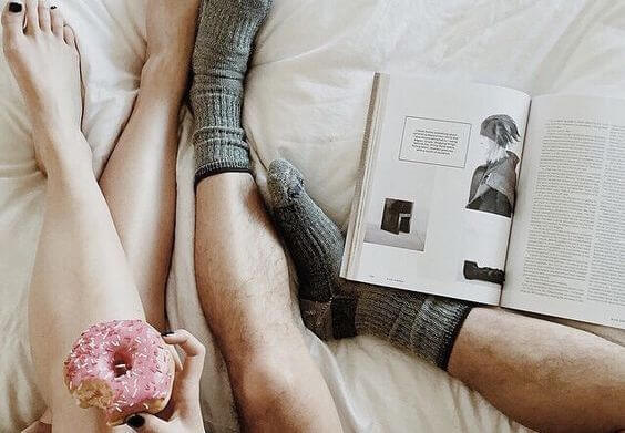 Couple's Legs In Bed