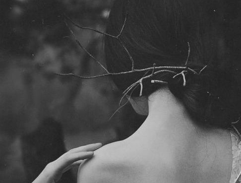 woman behind a branch