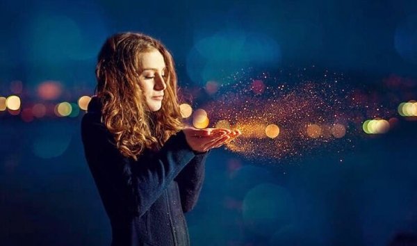 woman blowing dust