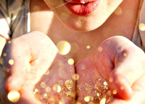 woman blowing glitter