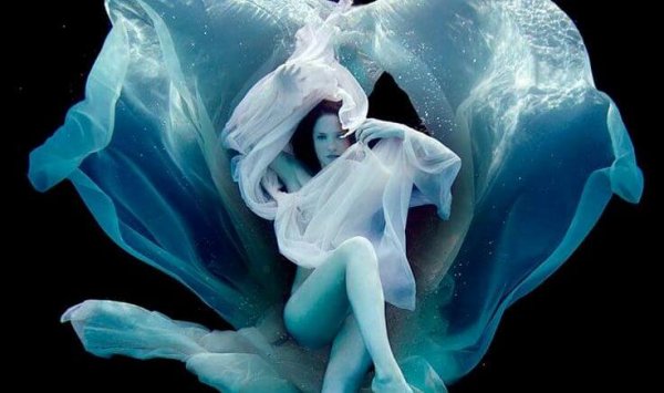 woman floating with veils
