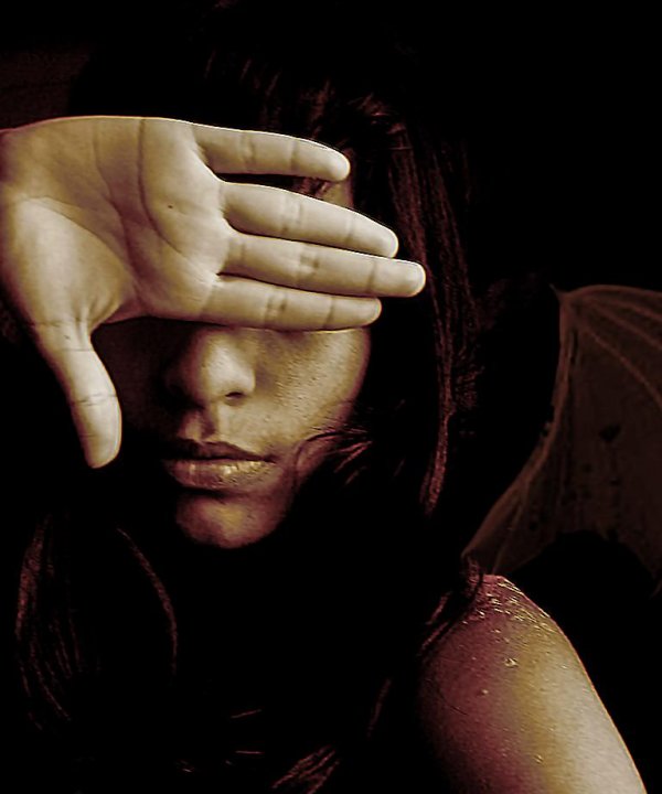 woman hiding behind her hand