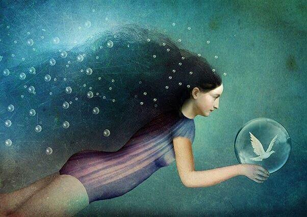 woman with bird in bubble underwater