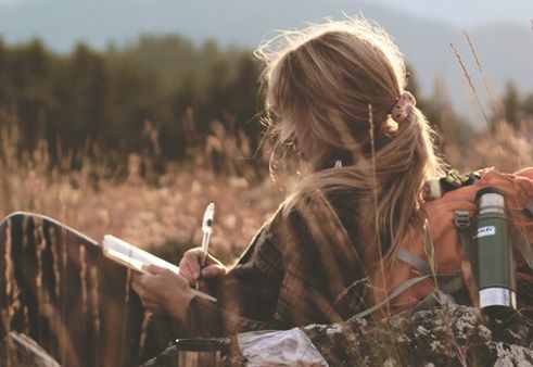 Girl Writing in Field