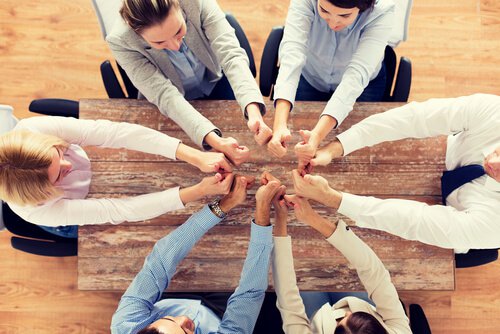 group-of-people-around-a-table-thumbs-up
