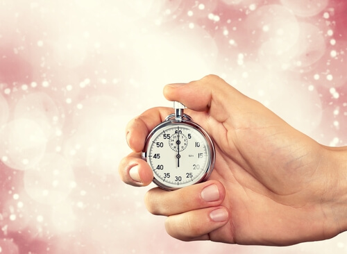 hand holding a clock