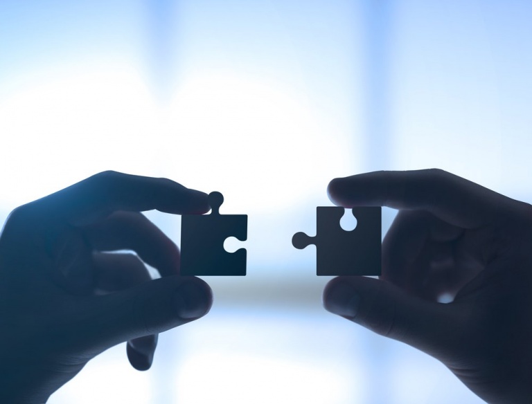 hands with two puzzle pieces-768x584