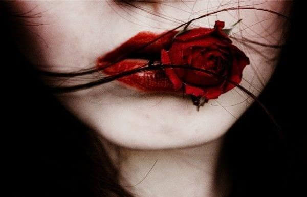 red-lips-holding-red-flower