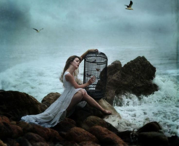 suffering woman sitting by the sea