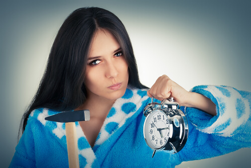 woman angry with her alarm clock