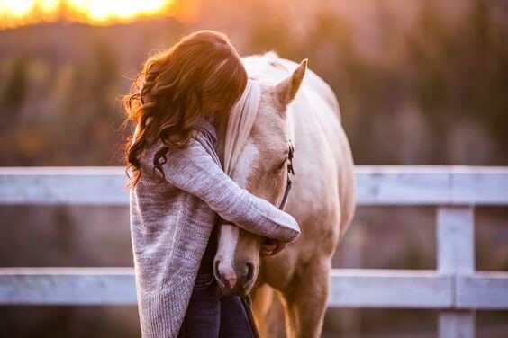woman hugging horse