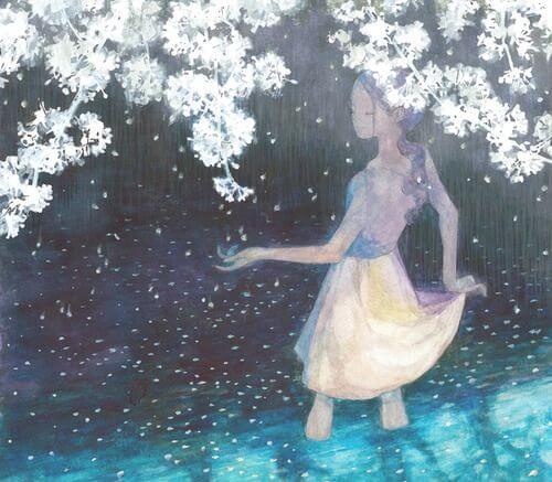 woman under white flowers enjoying being happy