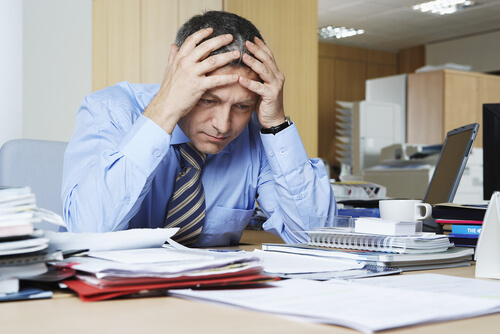 man dealing with psychological exhaustion at work