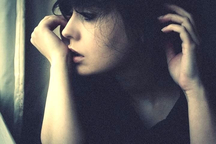 sad-woman-looking-out-window