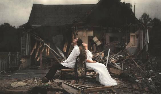 couple-in-front-of-a-destroyed-house