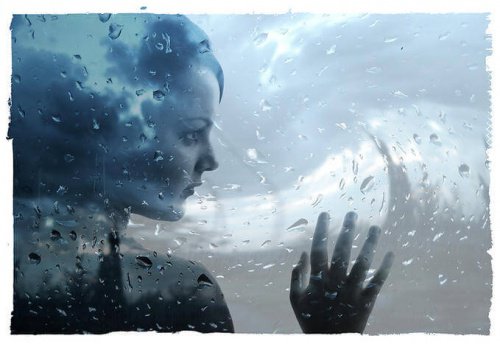 sad-woman-behind-wet-window