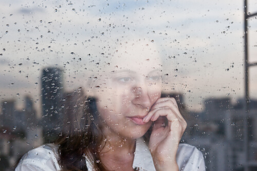 Woman Looking Out Rainy Window